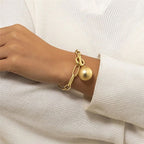 Ladies link bracelet with ball pendant in gold appearance