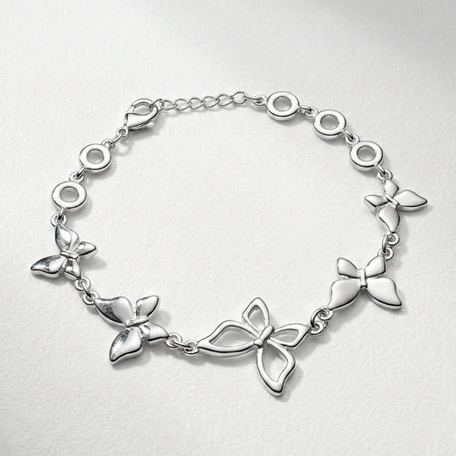 Damenarmband mit mehreren glatten Metallreihen und polierten Kugelenden, in silberner Optik am Handgelenk und als Detailansicht dargestellt