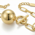 Ladies link bracelet with ball pendant in gold appearance