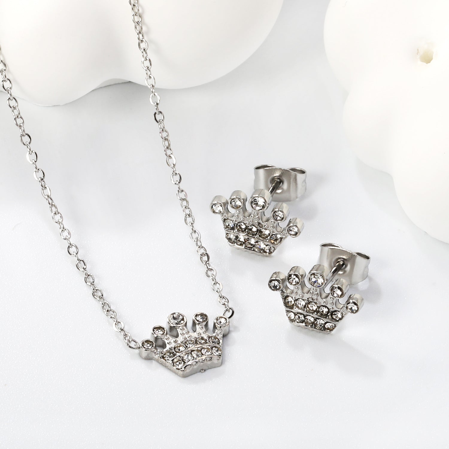 Women’s jewelry set with crown pendants and elegant stud earrings