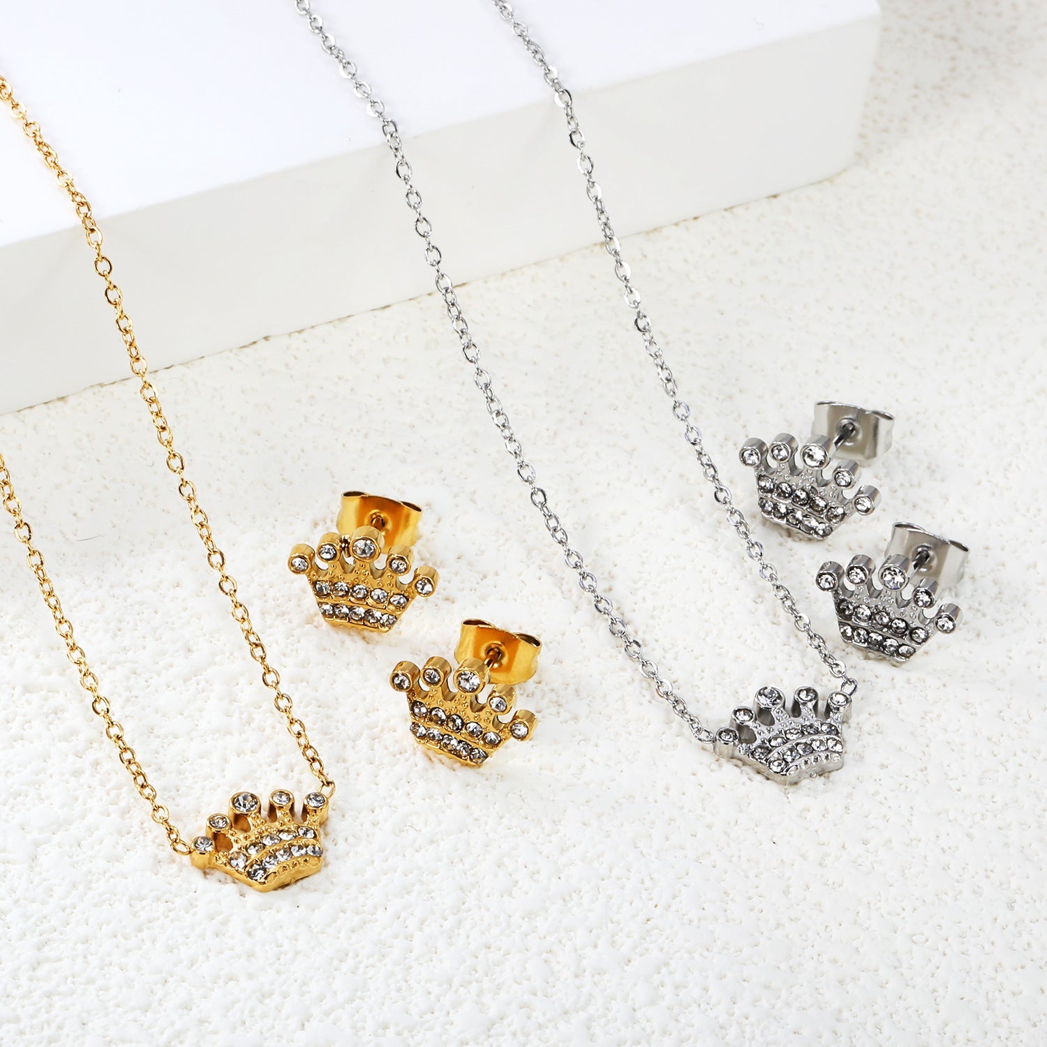 Women’s jewelry set with crown pendants and elegant stud earrings